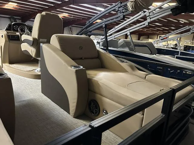 Slide: The Image of 2023 Lowe Retreat 230 RFL TLX pontoon boat interior with luxurious seating. - 9