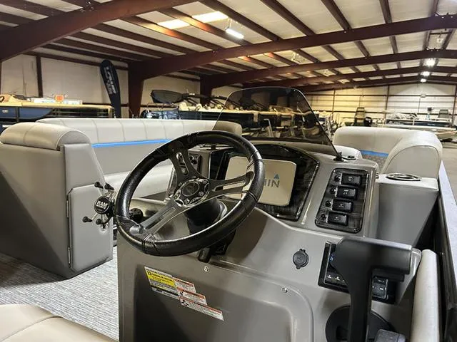 Slide: The Image of 2023 Qwest Pontoons 822 E-Class Splash Pad interior with steering wheel and control panel. - 13