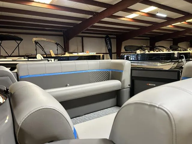 Slide: The Image of 2023 Qwest Pontoons 822 E-Class interior with gray seating in showroom. - 14