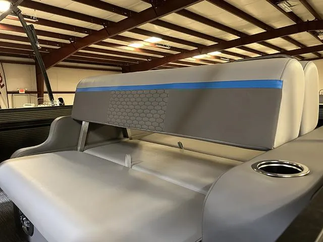 Slide: The Image of 2023 Qwest Pontoons 822 E-Class Splash Pad interior seating with cup holder in showroom. - 7