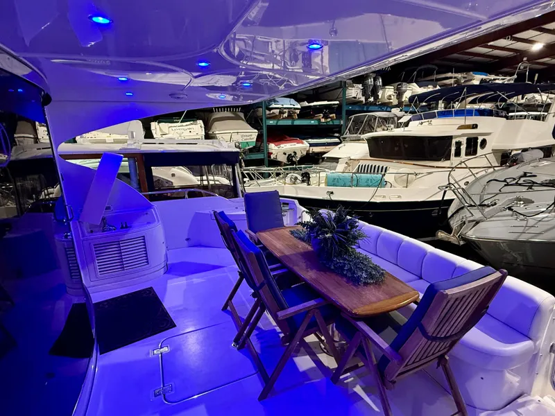Slide: The Image of Luxurious 2005 Marquis 65 yacht interior with elegant seating and ambient blue lighting. - 11