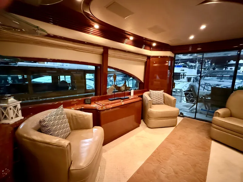 Slide: The Image of Luxurious interior of a 2005 Marquis 65 yacht with elegant seating and large windows. - 19