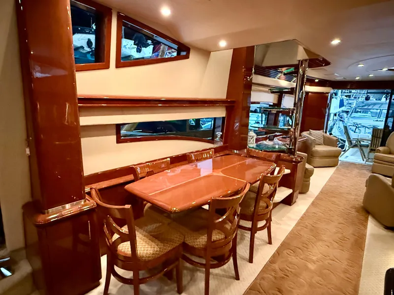 Slide: The Image of Luxurious interior of a 2005 Marquis 65 yacht with elegant dining area and seating. - 21