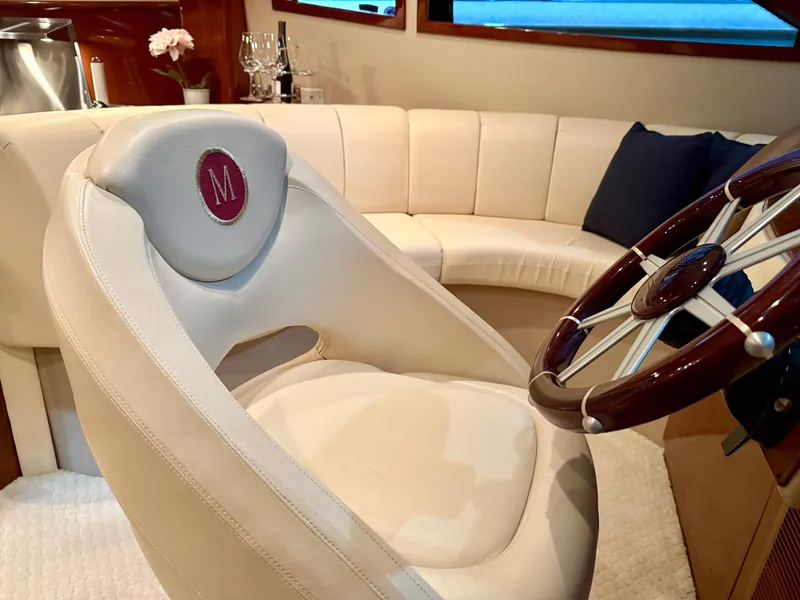 Slide: The Image of Luxurious interior of a 2005 Marquis 65 yacht with plush seating and elegant steering wheel. - 22