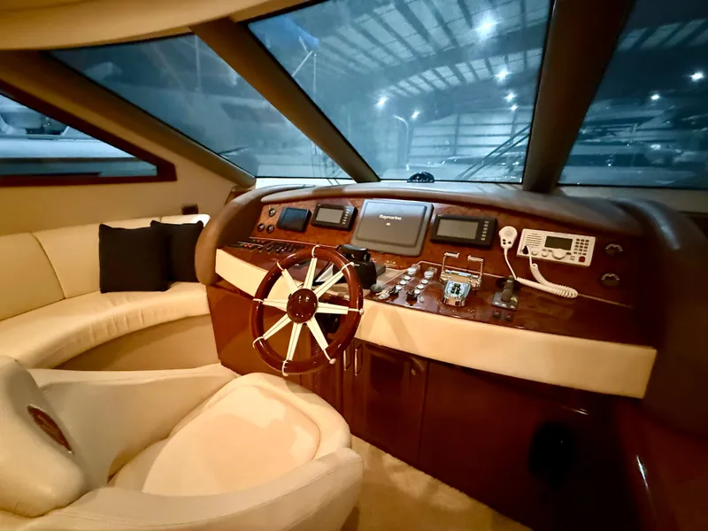 Slide: The Image of Luxurious 2005 Marquis 65 yacht helm with plush seating and advanced navigation controls. - 27