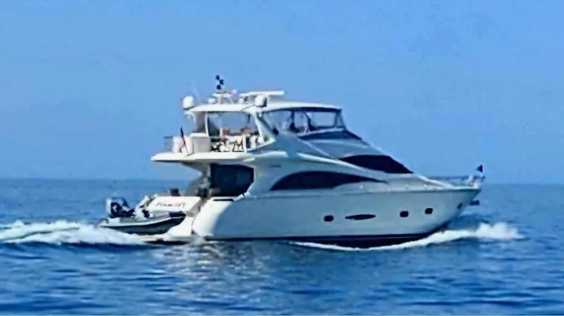 Slide: The Image of 2005 Marquis 65 yacht cruising on open water. - 3