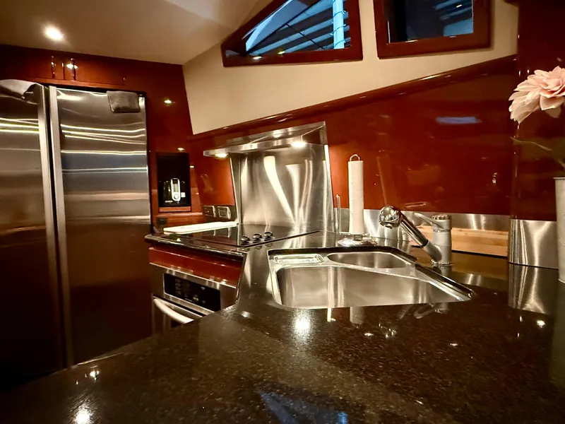 Slide: The Image of Luxurious kitchen interior of a 2005 Marquis 65 yacht with modern appliances and sleek design. - 33