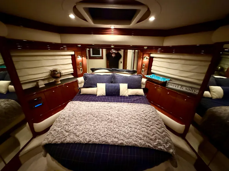 Slide: The Image of Luxurious bedroom interior of a 2005 Marquis 65 yacht with elegant bedding and wood accents. - 34