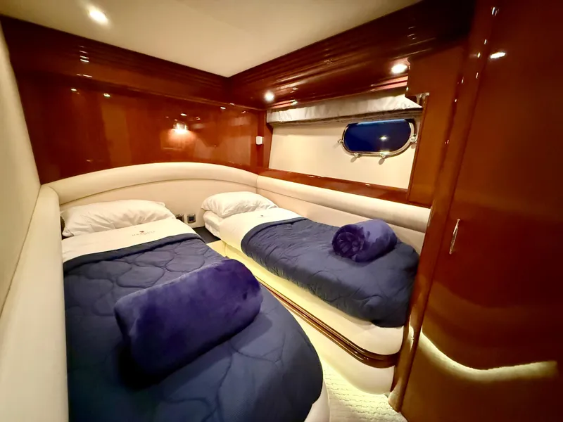 Slide: The Image of Luxurious twin cabin in 2005 Marquis 65 yacht with plush bedding and elegant wood finishes. - 39