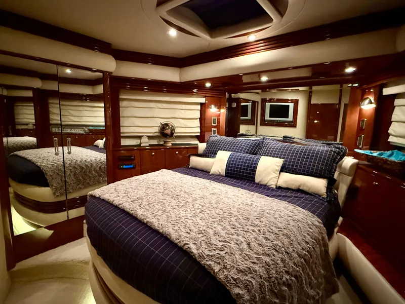 Slide: The Image of Luxurious bedroom interior of a 2005 Marquis 65 yacht with elegant bedding and ambient lighting. - 42