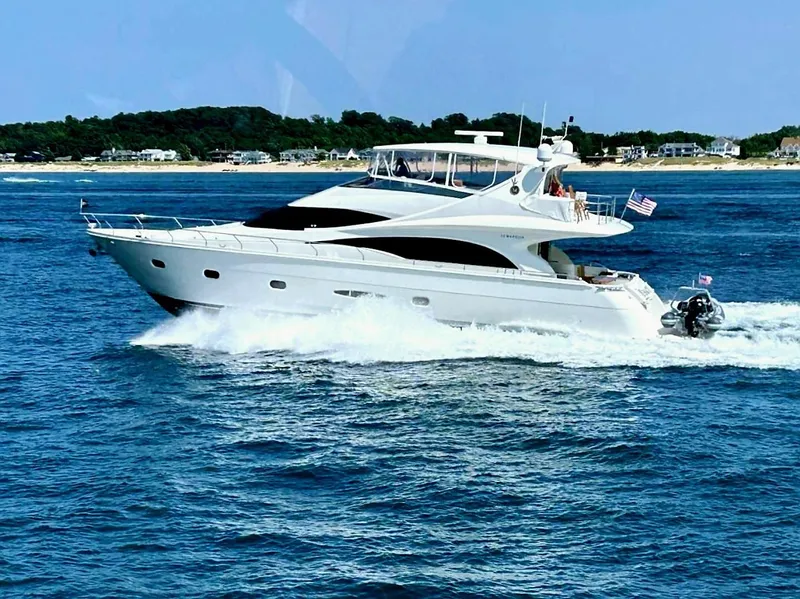 Slide: The Image of Luxury 2005 Marquis 65 yacht cruising on blue ocean near coastline. - 5