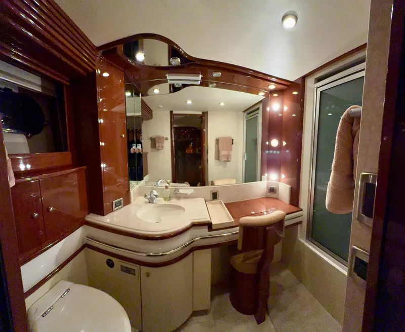 Slide: The Image of Luxurious bathroom interior in a 2005 Marquis 65 yacht, featuring elegant wood finishes and modern amenities. - 52
