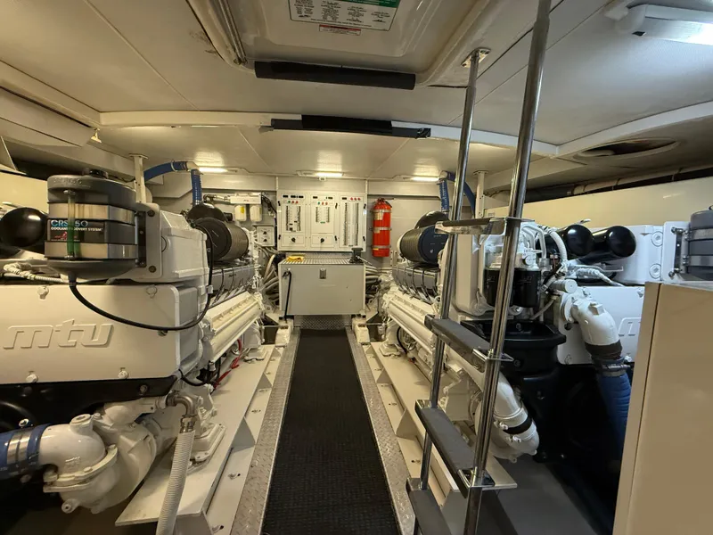 Slide: The Image of Engine room of a 2005 Marquis 65 yacht, featuring dual MTU engines. - 54