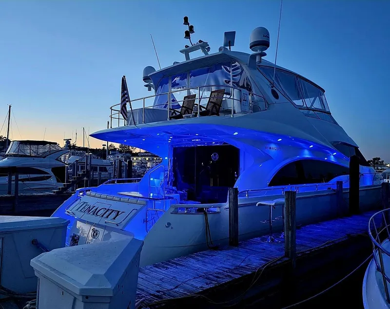 Slide: The Image of Luxurious 2005 Marquis 65 yacht docked at sunset with blue LED lights. - 7