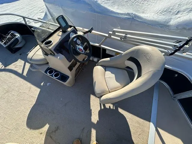 Slide: The Image of 2012 Sun Tracker Bass Buggy 18 DLX boat interior with steering console and seating. - 2