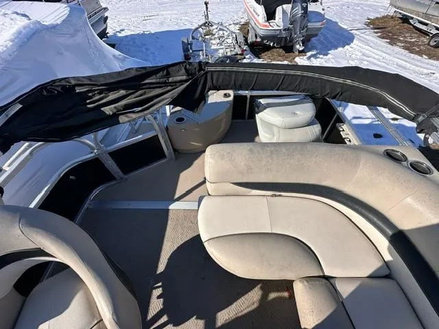 Slide: The Image of 2012 Sun Tracker Bass Buggy 18 DLX pontoon boat interior with seating and cup holders. - 3