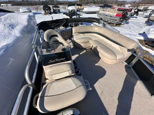 Slide: The Image of 2012 Sun Tracker Bass Buggy 18 DLX pontoon boat with beige seating in snowy outdoor setting. - 9