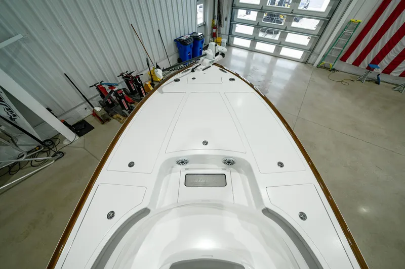 Slide: The Image of 2024 Valhalla Boatworks V-28 in a garage, showcasing sleek deck design. - 11