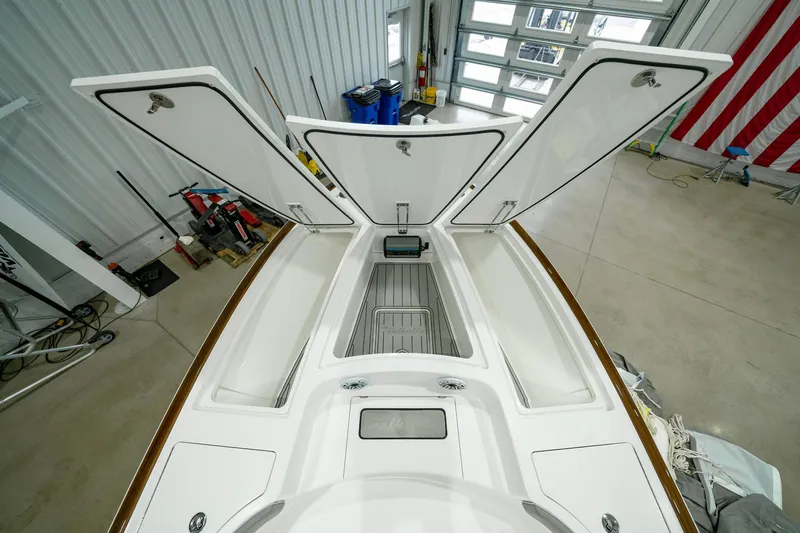 Slide: The Image of 2024 Valhalla Boatworks V-28 interior storage compartments in a garage setting. - 12