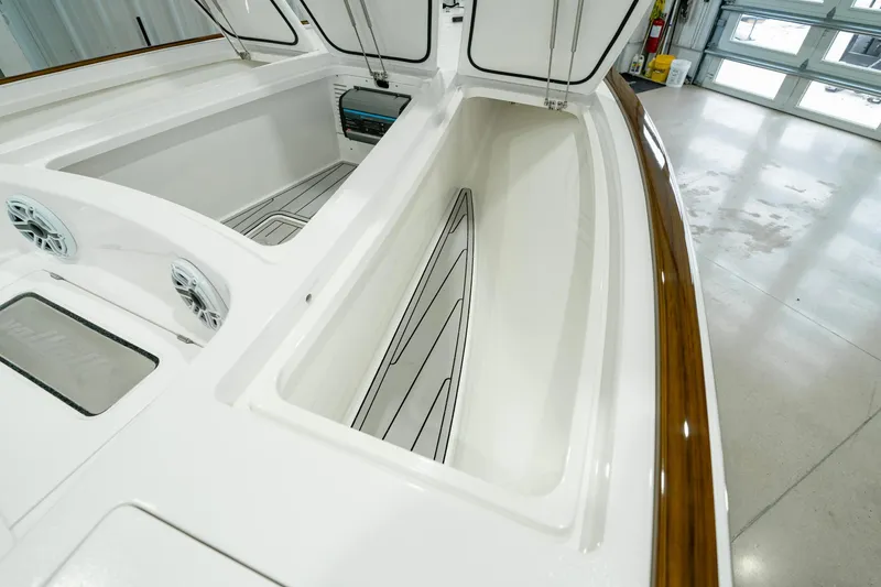 Slide: The Image of 2024 Valhalla Boatworks V-28 interior with open storage compartments and sleek design. - 14