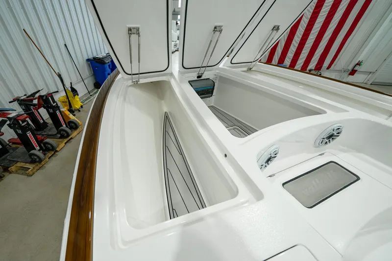 Slide: The Image of 2024 Valhalla Boatworks V-28 storage compartments with open hatches in a showroom. - 15