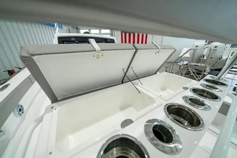 Slide: The Image of 2024 Valhalla Boatworks V-28 interior with open storage compartments and cup holders. - 33