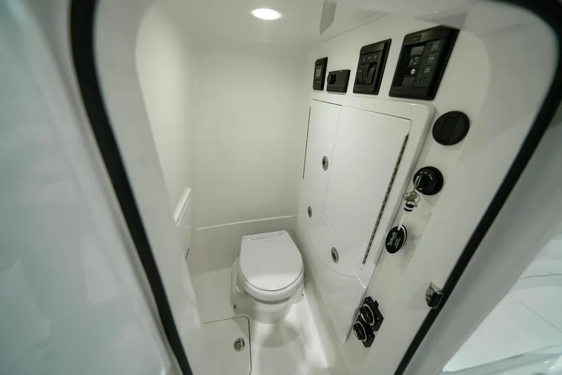 Slide: The Image of 2024 Valhalla Boatworks V-28 interior bathroom with modern fixtures and control panels. - 36
