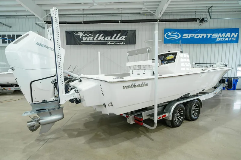 Slide: The Image of 2024 Valhalla Boatworks V-28 on trailer in showroom, featuring Mercury outboard engine. - 5