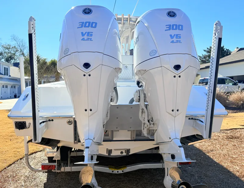 Slide: The Image of 2024 SeaHunter 28 Floridian with twin 300 V6 outboard engines, rear view. - 11