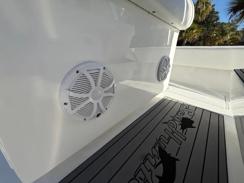 Slide: The Image of 2024 SeaHunter 28 Floridian boat interior with speakers and branded flooring. - 14