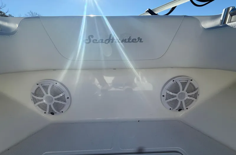 Slide: The Image of 2024 SeaHunter 28 Floridian boat interior with speakers and sunlight reflections. - 15