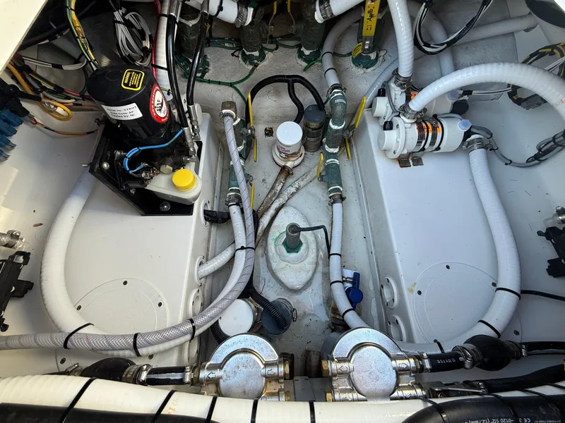 Slide: The Image of Engine compartment of 2024 SeaHunter 28 Floridian with visible hoses and components. - 17