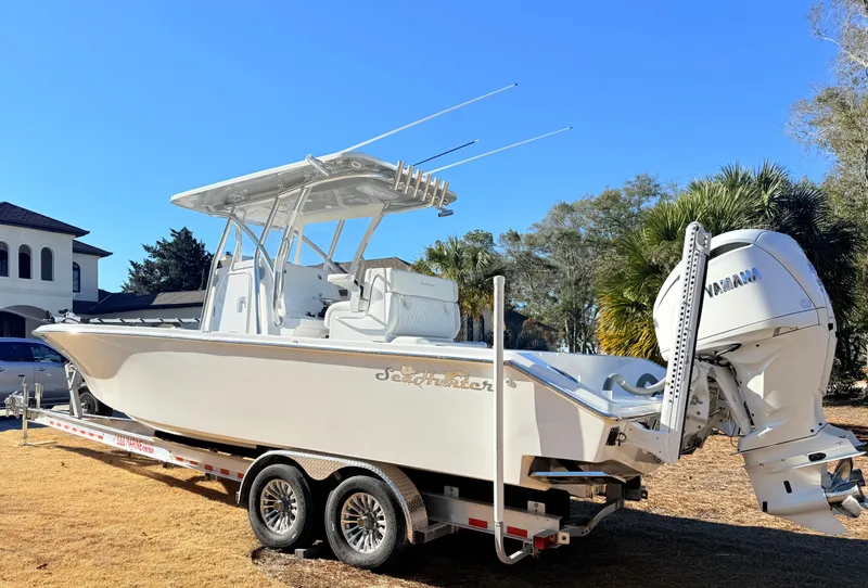 Slide: The Image of 2024 SeaHunter 28 Floridian boat on trailer, featuring Yamaha outboard motor. - 2