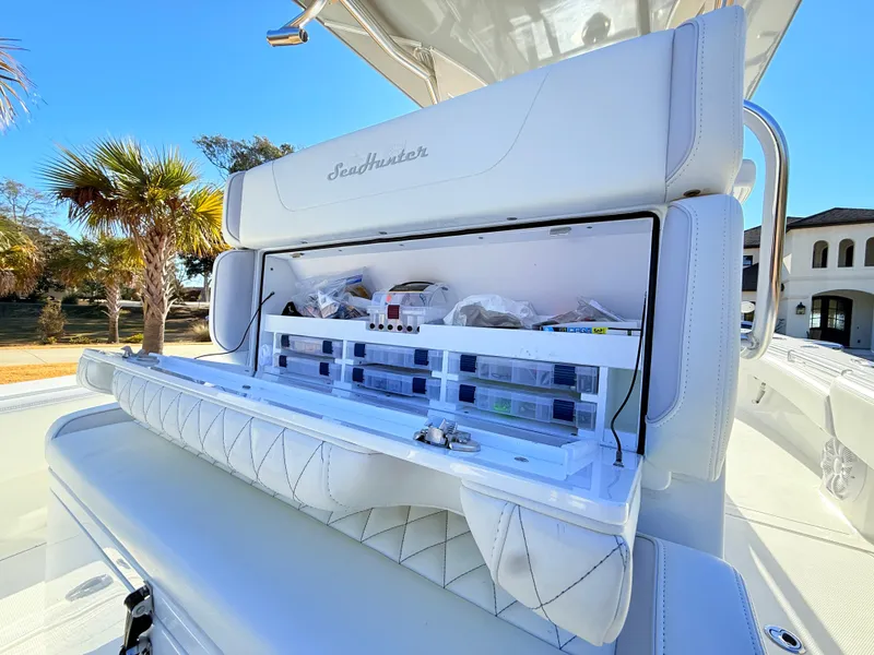 Slide: The Image of 2024 SeaHunter 28 Floridian boat with open storage compartment, showcasing organized fishing gear. - 21