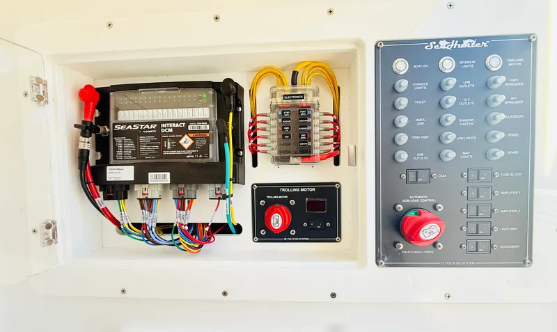 Slide: The Image of 2024 SeaHunter 28 Floridian electrical panel with battery and control switches. - 22