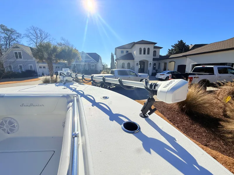 Slide: The Image of 2024 SeaHunter 28 Floridian boat parked in a sunny residential neighborhood. - 23