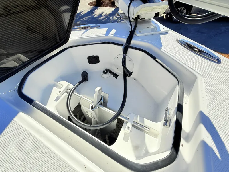 Slide: The Image of 2024 SeaHunter 28 Floridian anchor compartment with open hatch and visible wiring. - 25