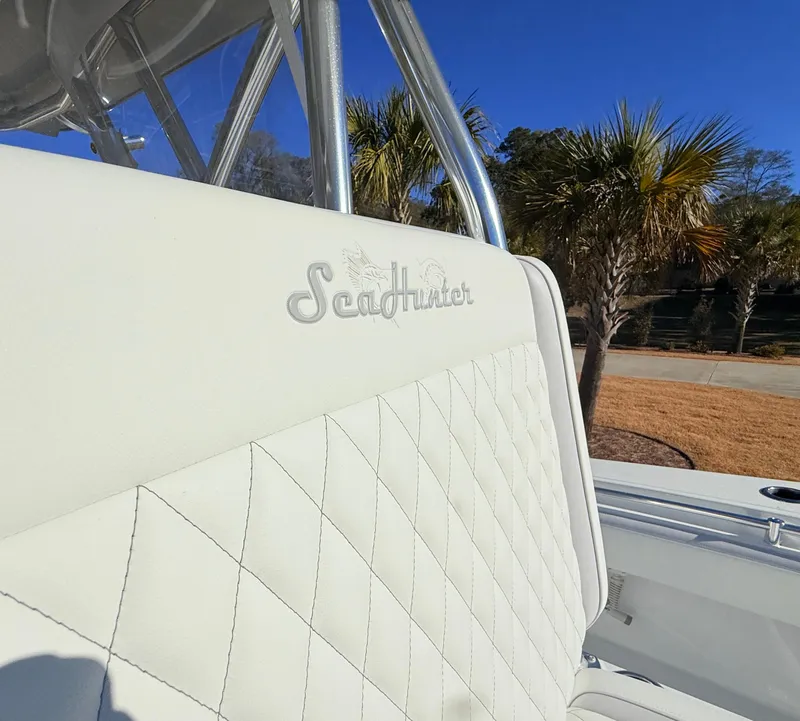 Slide: The Image of 2024 SeaHunter 28 Floridian boat seat with logo, palm trees in background. - 30
