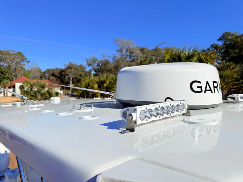 Slide: The Image of 2024 SeaHunter 28 Floridian boat with Garmin radar, clear blue sky background. - 31