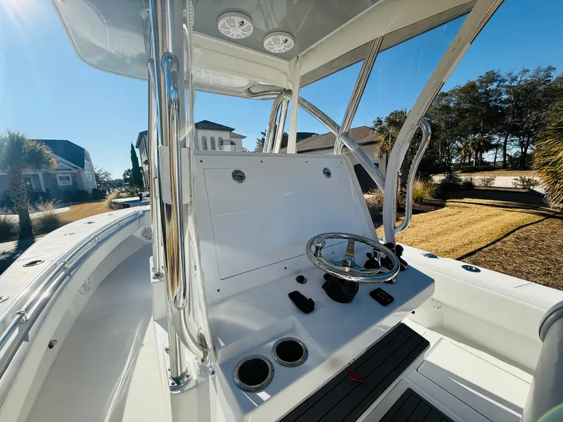 Slide: The Image of 2024 SeaHunter 28 Floridian boat interior with steering console and cup holders. - 9