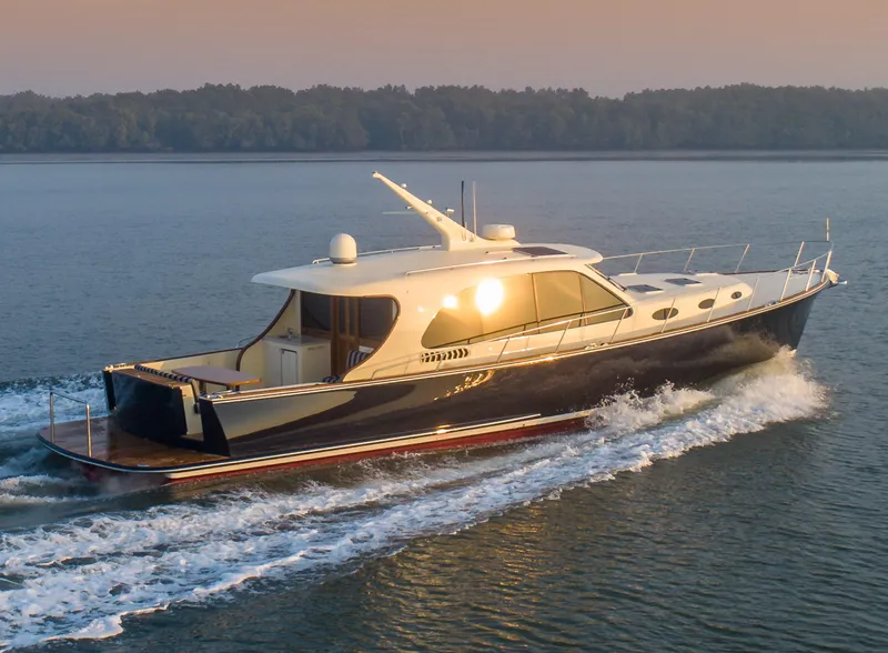 Slide: The Image of 2026 Palm Beach Motor Yachts PB55 cruising on calm waters at sunset. - 14