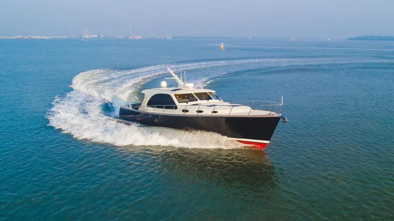 Slide: The Image of 2026 Palm Beach Motor Yachts PB55 cruising on open water. - 15