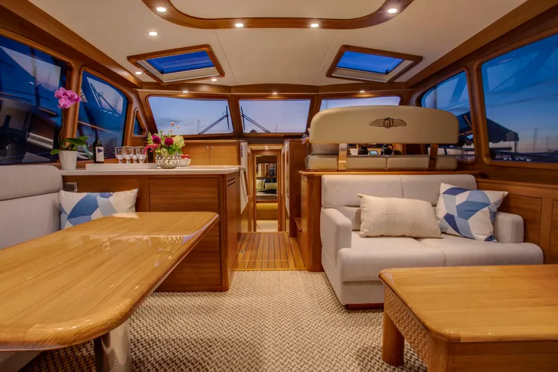 Slide: The Image of Luxurious interior of 2026 Palm Beach Motor Yachts PB55, featuring elegant wood finishes and plush seating. - 2