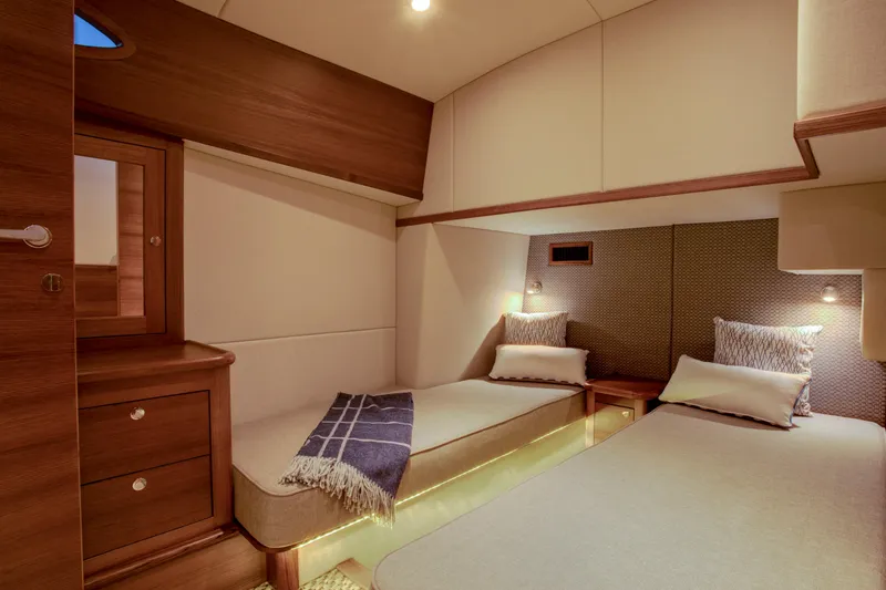 Slide: The Image of Luxurious cabin interior of 2026 Palm Beach Motor Yachts PB55 with twin beds. - 8