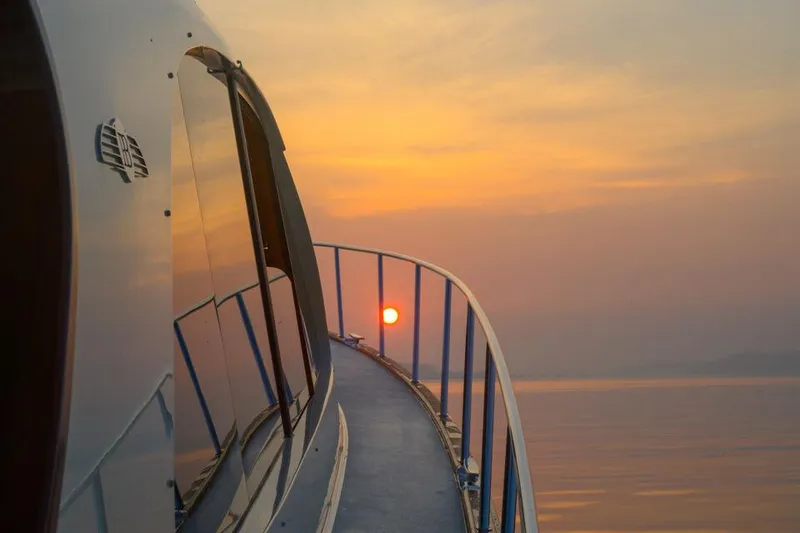 Slide: The Image of 2026 Palm Beach Motor Yachts PB55 at sunset, reflecting serene ocean view. - 11