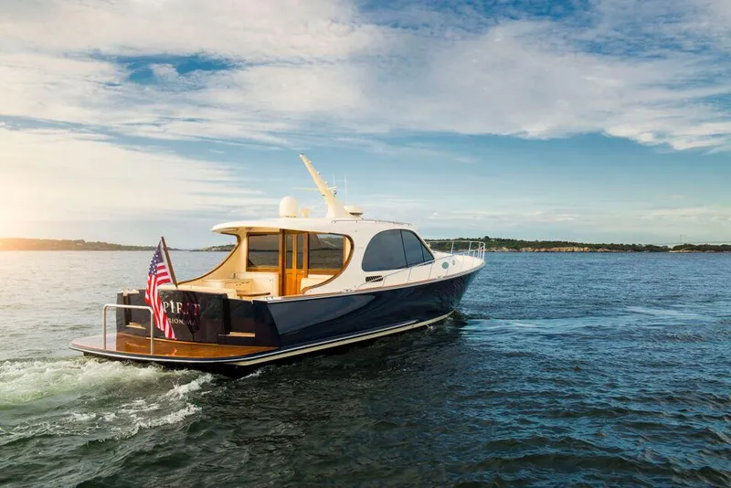 Slide: The Image of 2026 Palm Beach Motor Yachts PB55 cruising on open water under a clear sky. - 13