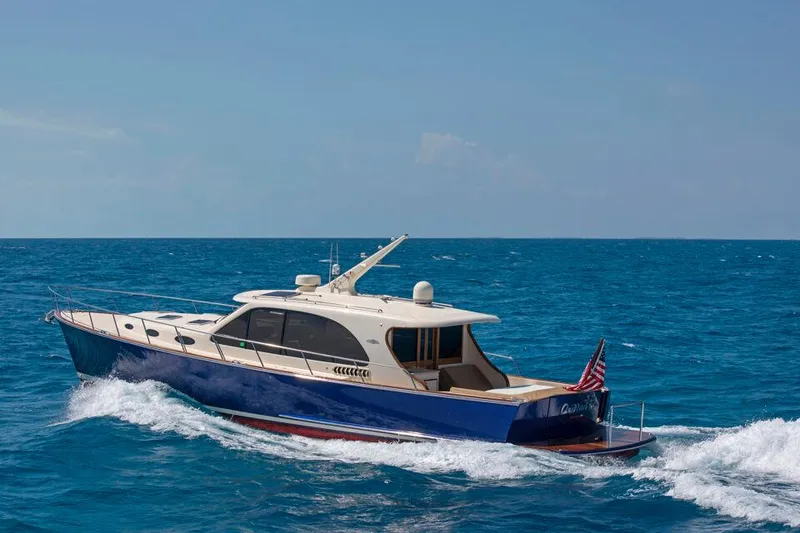 Slide: The Image of 2026 Palm Beach Motor Yachts PB55 cruising on open blue sea. - 18