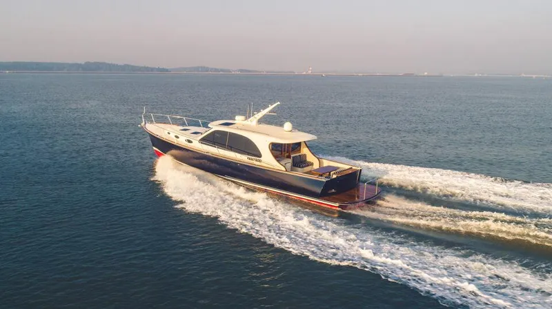 Slide: The Image of 2026 Palm Beach Motor Yachts PB55 cruising on open water. - 19