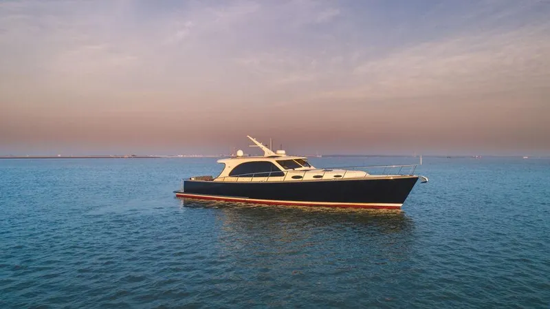 Slide: The Image of 2026 Palm Beach Motor Yachts PB55 cruising on calm ocean waters at sunset. - 21
