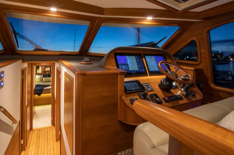 Slide: The Image of Luxurious 2026 Palm Beach Motor Yachts PB55 interior with elegant wood finish and modern navigation. - 6